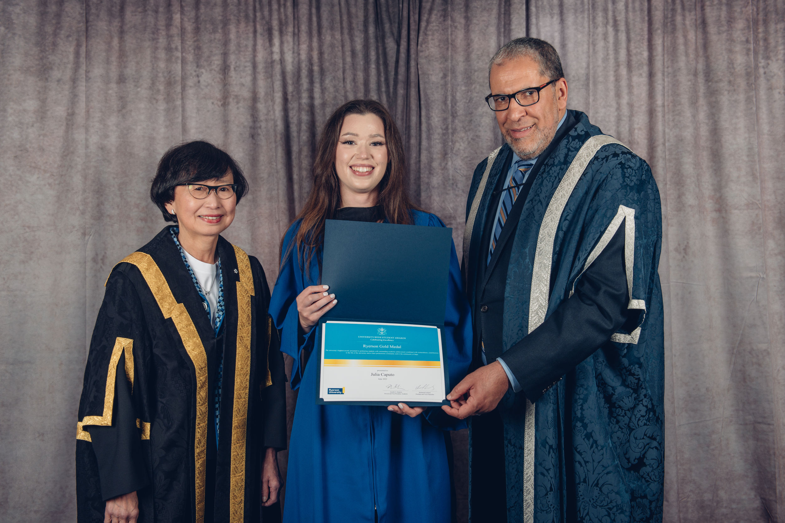 Chancellor Janice Fukakusa (left), and President Mohamed Lachemi (right) award Criminology student Julia Caputo with Faculty of Arts Gold medal in June 2022.